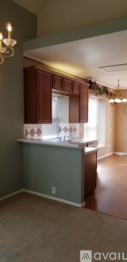 A kitchen with brown cabinets and a countertop.