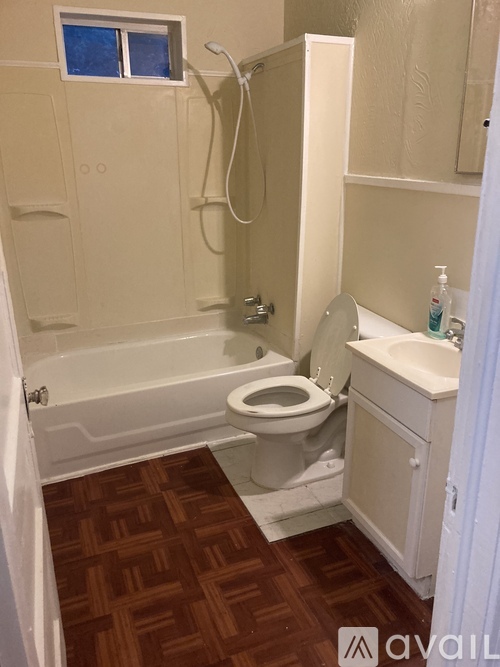 A bathroom with a toilet, sink, and bathtub.
