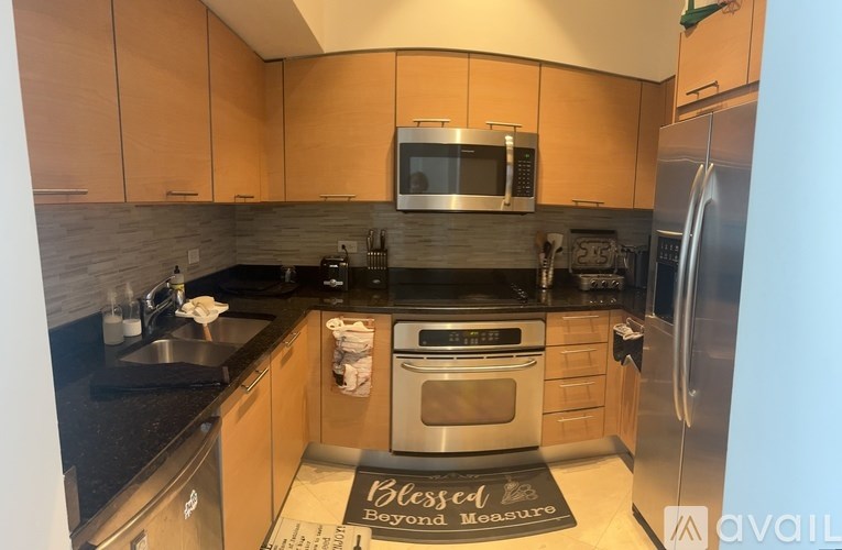 A kitchen with wooden cabinets and a black countertop.