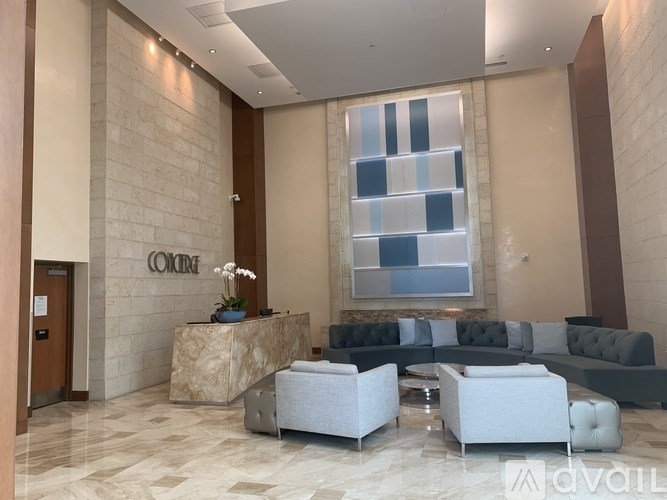 A reception area with a reception desk and a sofa.