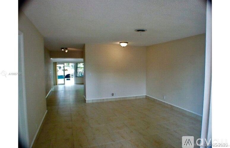A room with wooden flooring and white walls.