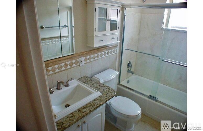 A bathroom with a sink, toilet, and shower.