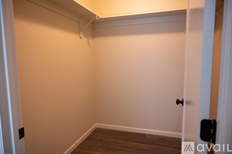 A room with a door and a wall socket.