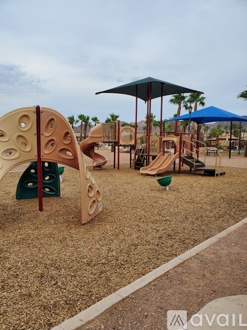 A playground with a slide, swings, and a climbing structure.