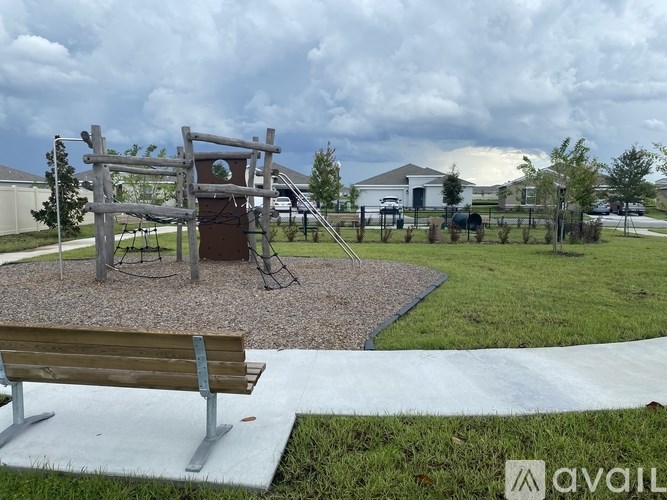 A playground with a swing set and a wooden structure.