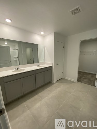 A bathroom with two sinks and a large mirror.