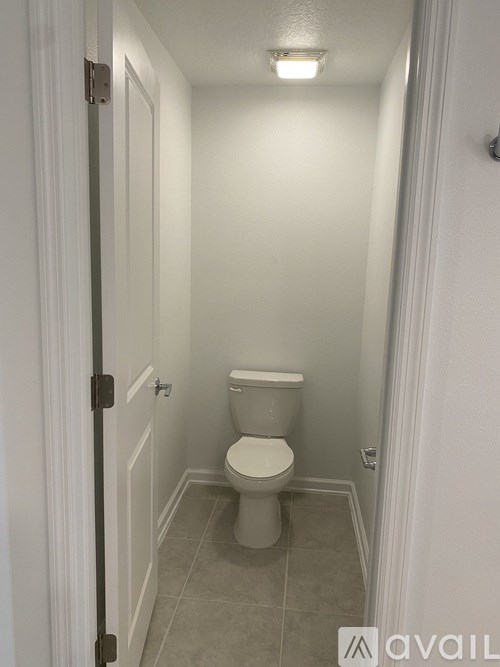 A white toilet in a small bathroom.