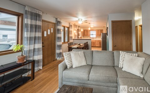 A living room with a grey couch and a coffee table.