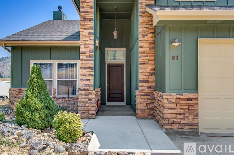 A house with a brown door and a number 21 on the front door.