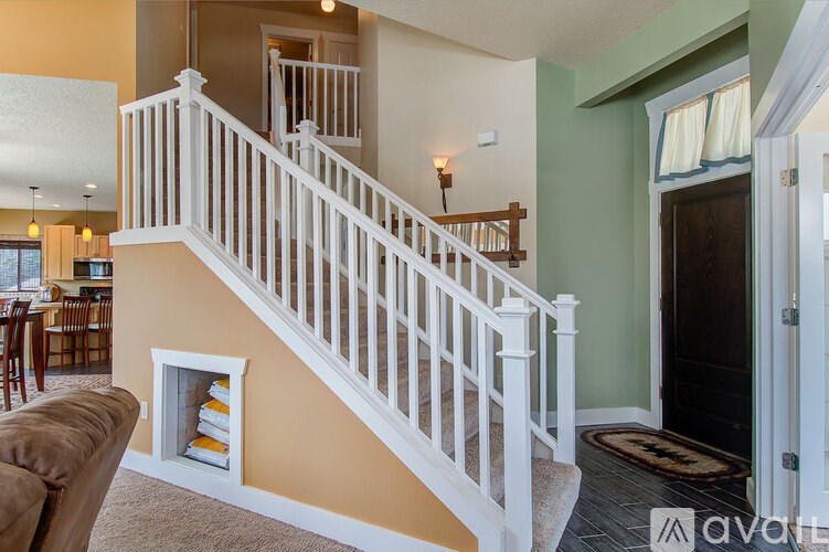 A living room with a staircase leading to the upper floor.