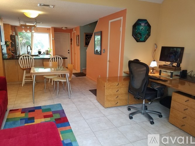 A living room with a dining table and chairs.