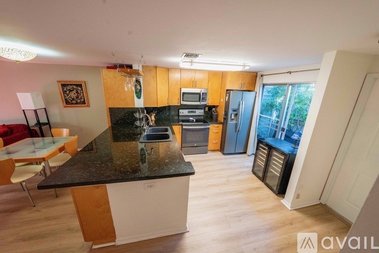 A clock hangs on the wall above a staircase.