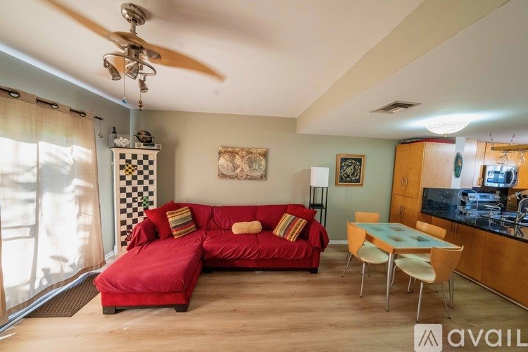 A swimming pool surrounded by palm trees and a white building.
