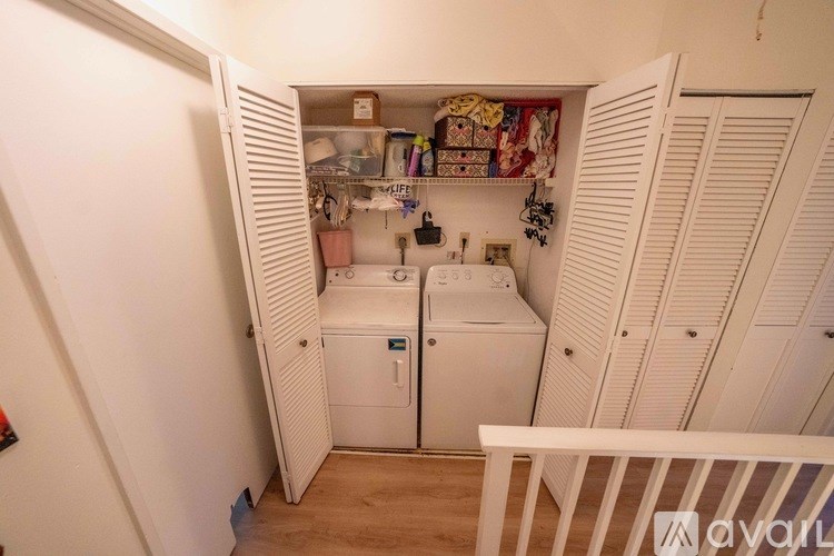 A small laundry room with a washer and dryer.