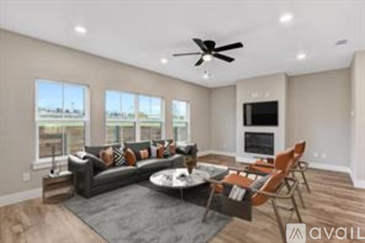 A living room with a grey sofa and a black coffee table.
