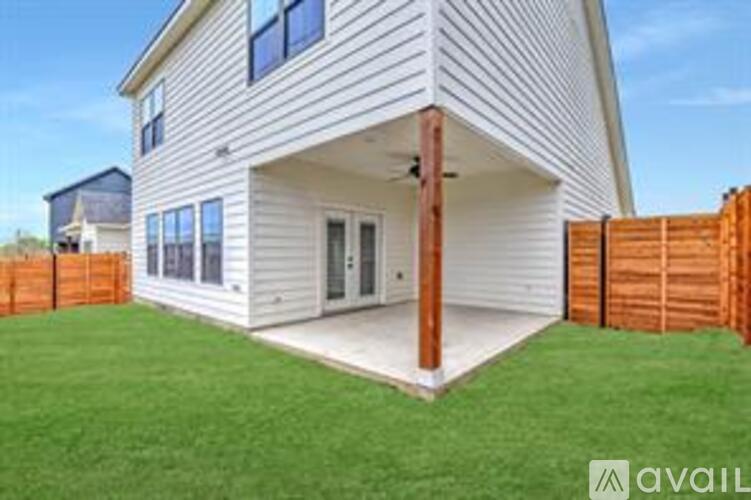 A house with a white exterior and a wooden fence.