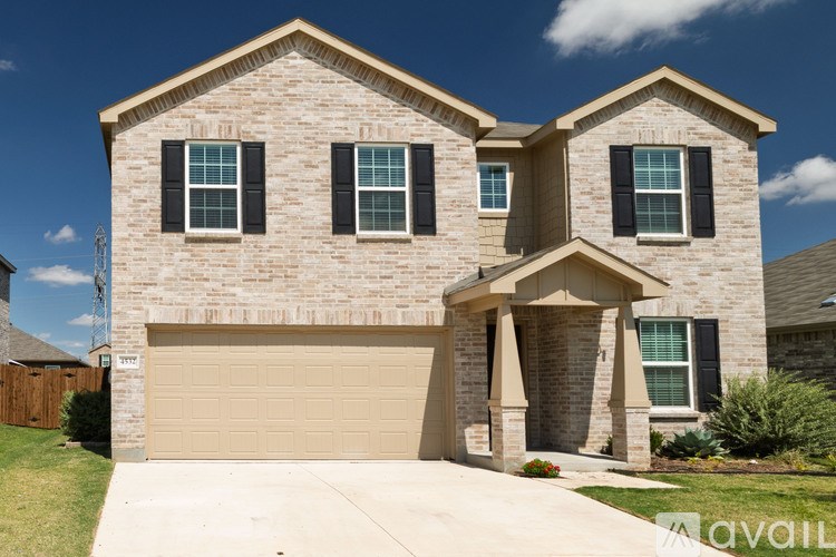 A house with a garage and a driveway is for sale.