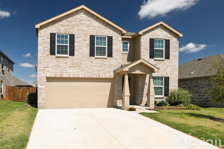 A two-story house with a garage is shown in the image.
