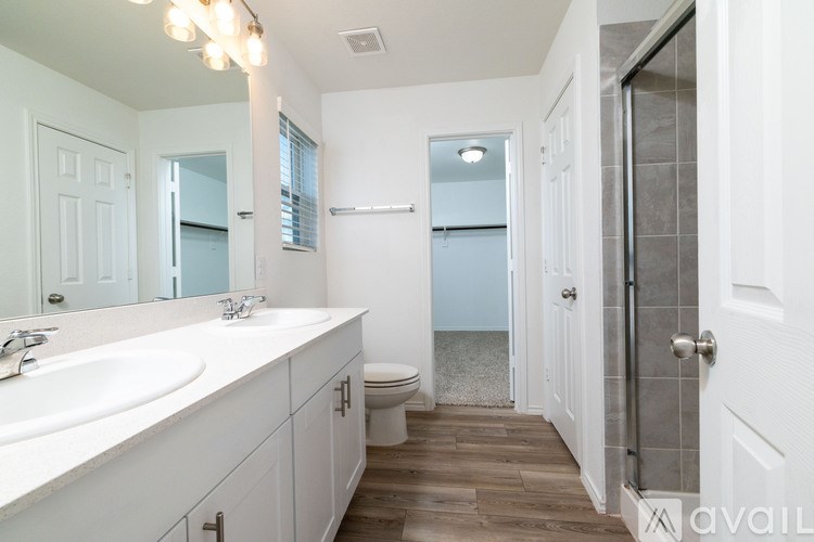 A bathroom with a white sink and a toilet.