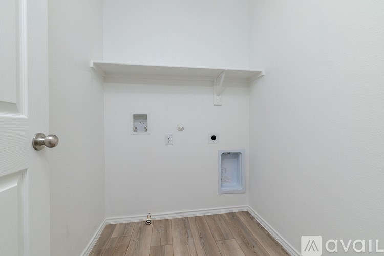 A white wall with a door and a small window.