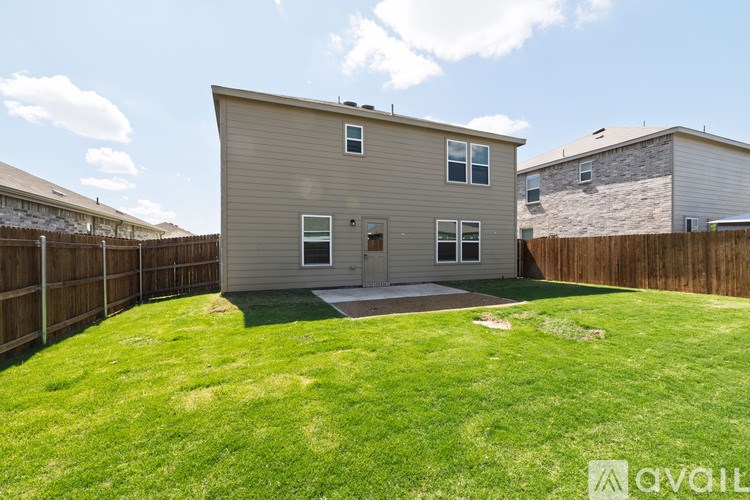 A house with a fenced yard is for sale.