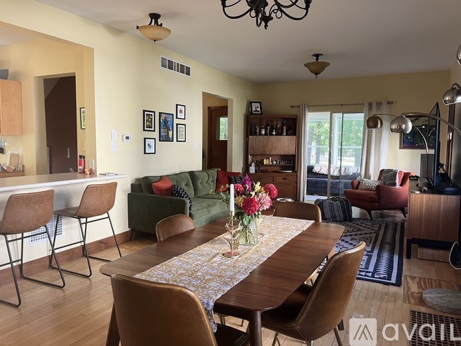 A dining room with a table set for six.
