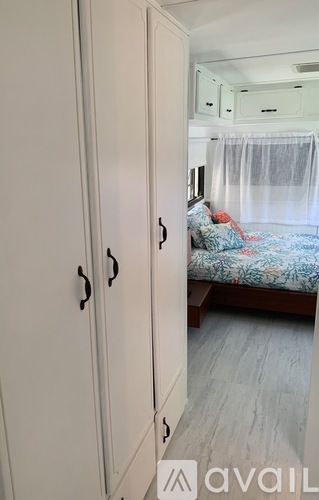 A bedroom with a bed and a wardrobe.