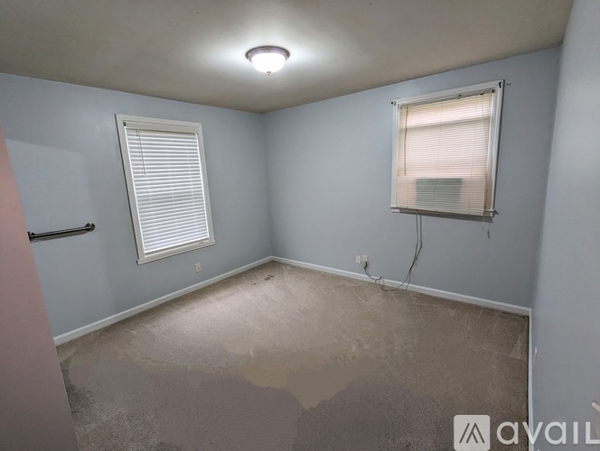 A room with a window and a wall socket.