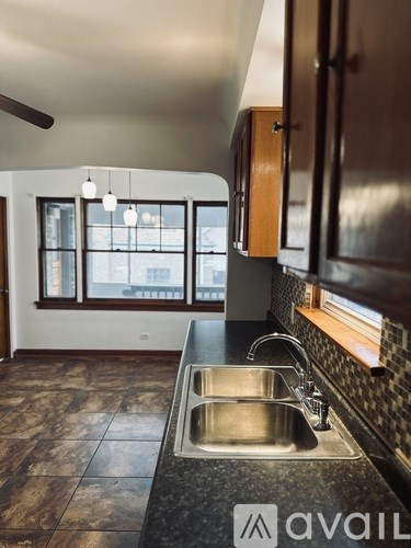 A kitchen with a sink and a window.