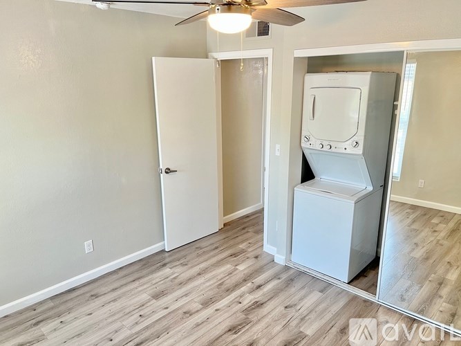 A room with a white door and a white appliance in it.