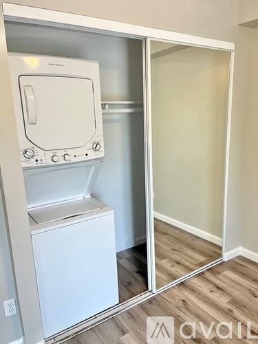 A white dishwasher and dryer are in a small room.