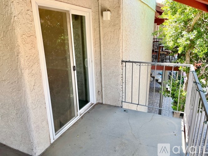 A balcony with a glass door and a metal railing.
