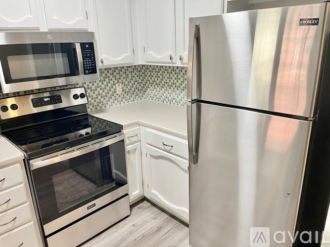 A kitchen with a stainless steel refrigerator and oven.