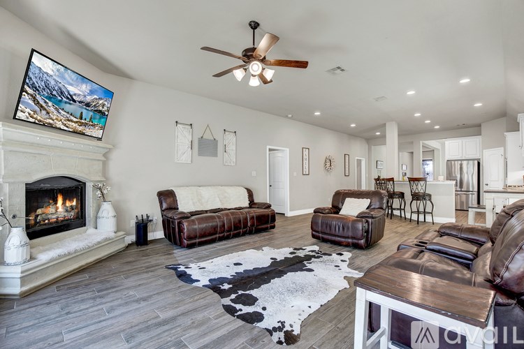 A living room with a fireplace and a painting on the wall.