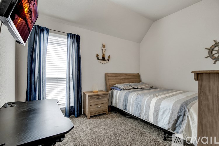 A bedroom with a bed, nightstand, and a television.