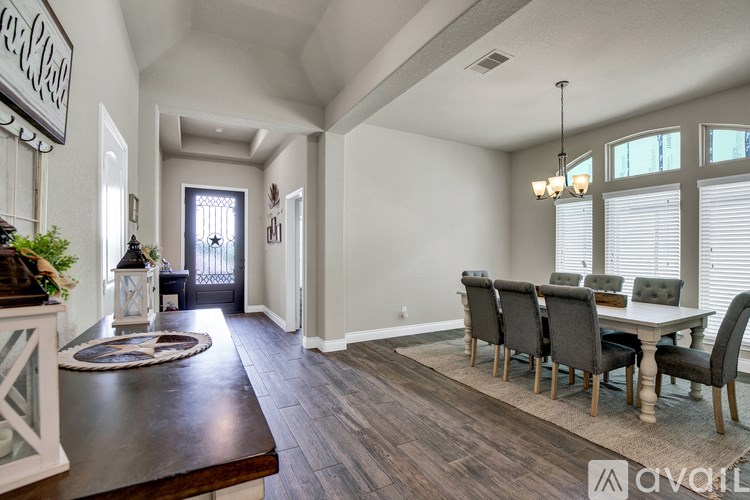 A dining room with a wooden table and chairs.