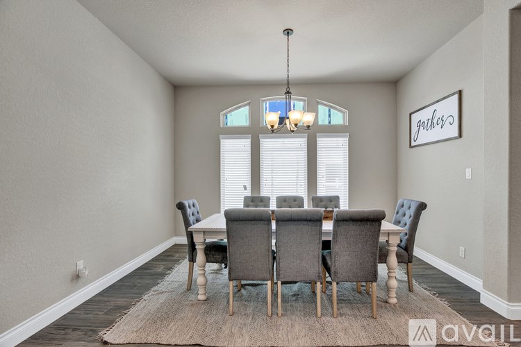 A dining room with a table set for six.