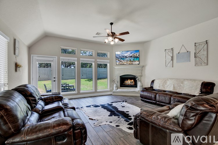 A living room with a fireplace and a television.