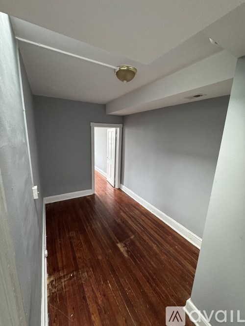 A room with wooden floors and a white ceiling.