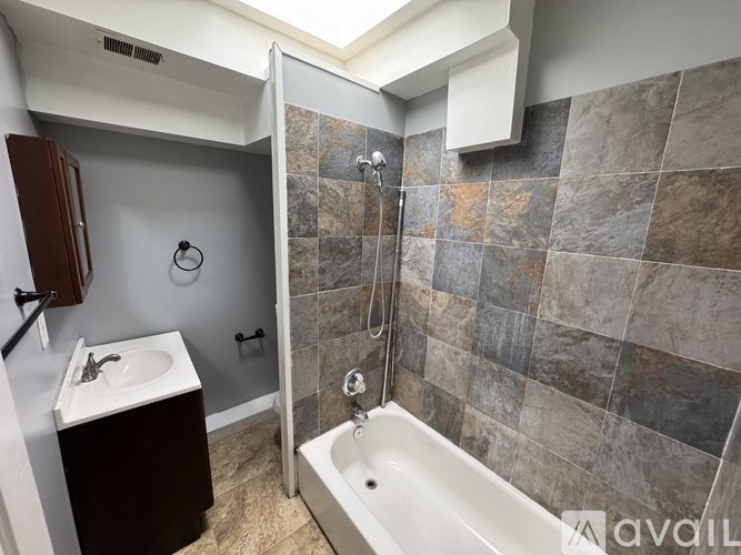 A bathroom with a walk-in shower and a sink.
