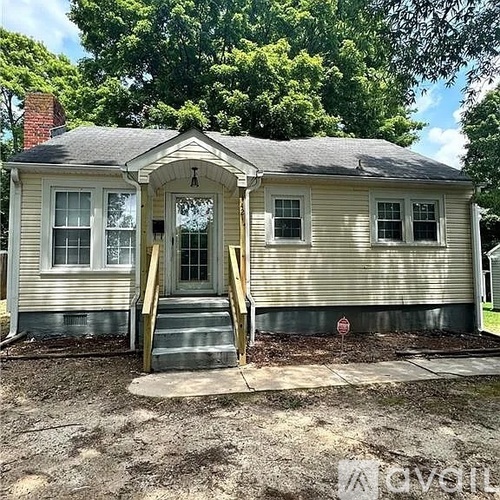 A small house with a porch and a front door.