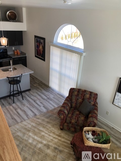 A kitchen with a counter and a chair.
