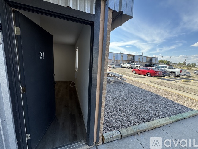 A blue door with the number 21 on it is open.
