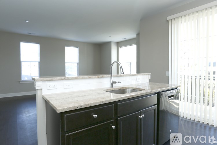 A kitchen with a sink and a window.