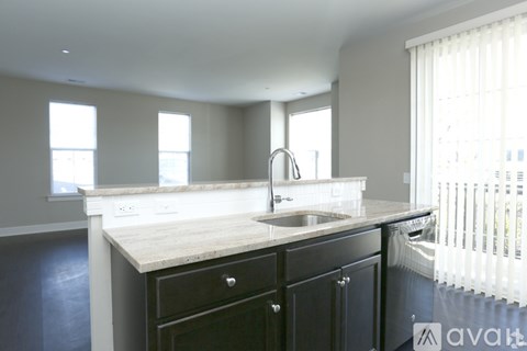 A kitchen with a sink and a window.