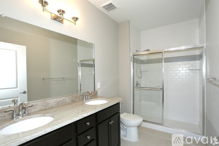 A bathroom with a sink, toilet, and shower.