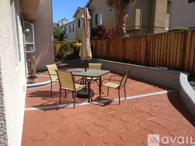 A patio with a table and chairs is shown.
