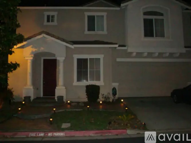 A house with a red door and a sign that says "Fire Lamp - No Parking".