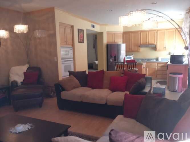 A living room with a couch, chairs, and a coffee table.