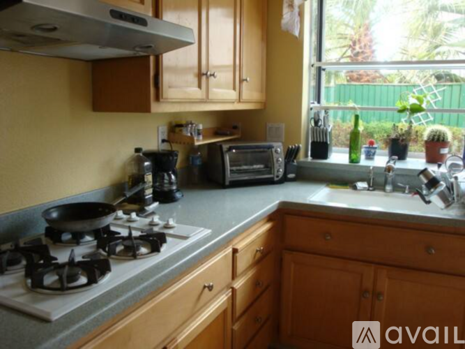 A kitchen with a stove, oven, and a window.